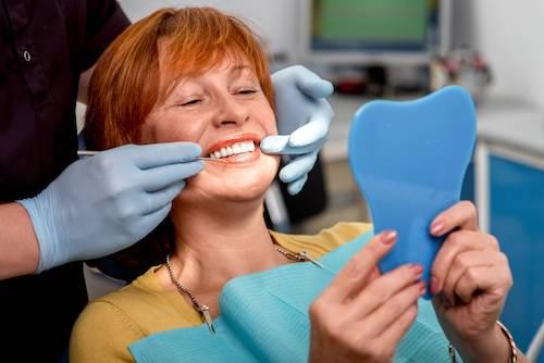 A woman reviewing her cosmetic dental work | cosmetic dentist lakeville mn