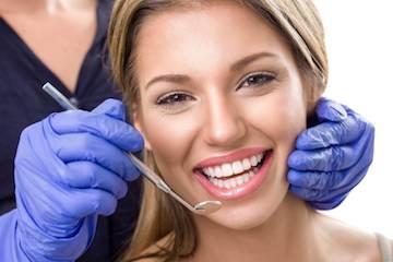 A woman receiving a dental exam | dentist lakeville mn