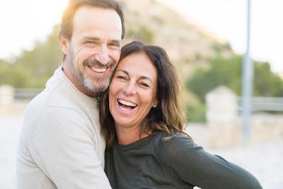 middleaged couple hugging | dentist lakeville mn
