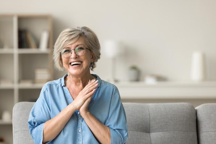 older woman with glasses smiling | dental implants lakeville mn
