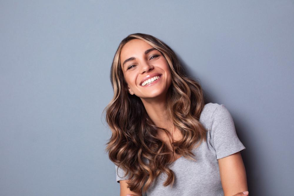 woman with brown hair smiling | cosmetic dentist lakeville mn