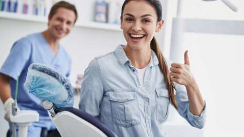 woman in jean shirt smiling | dentist in lakeville